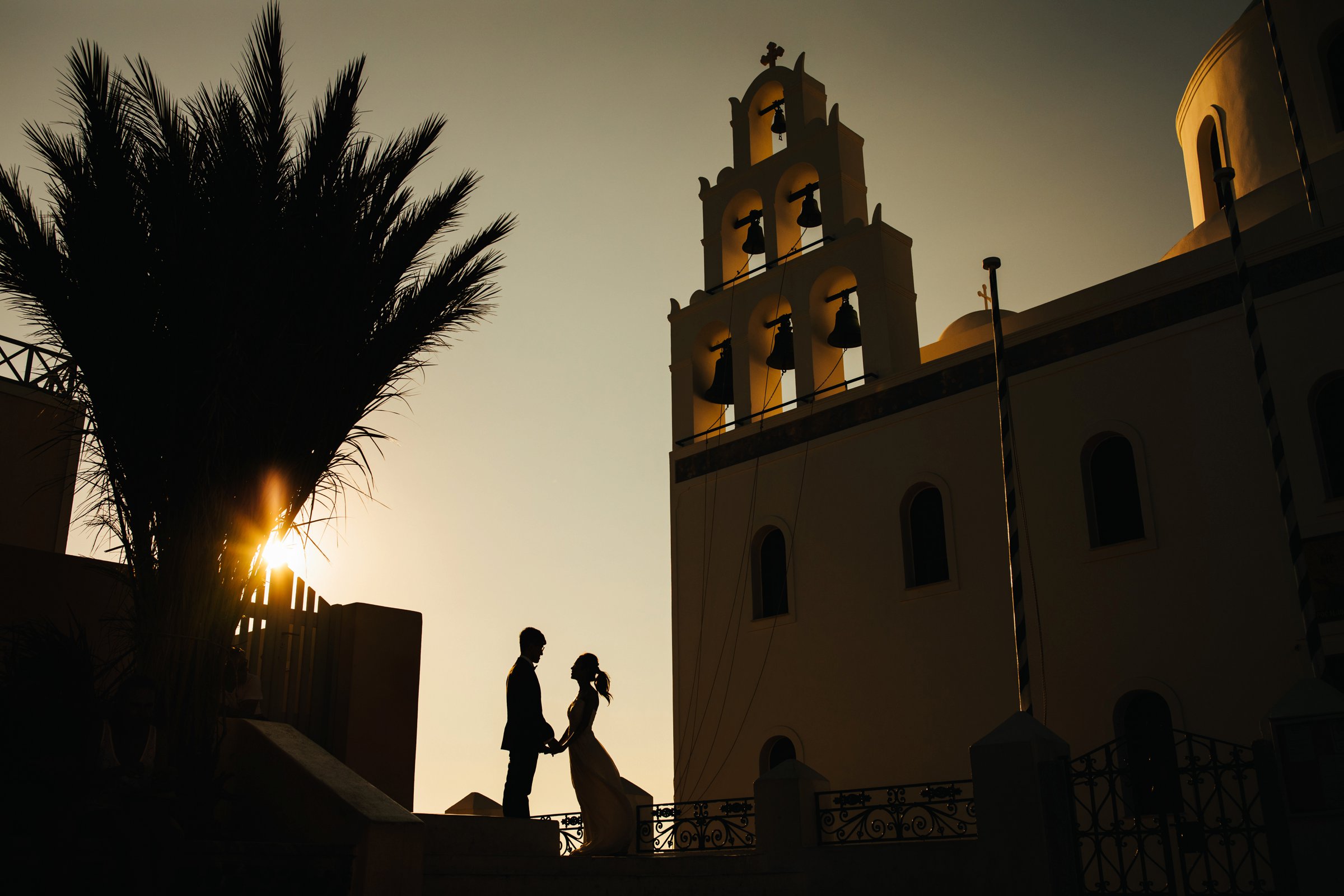 a silhouette of a bride and groom in santorini