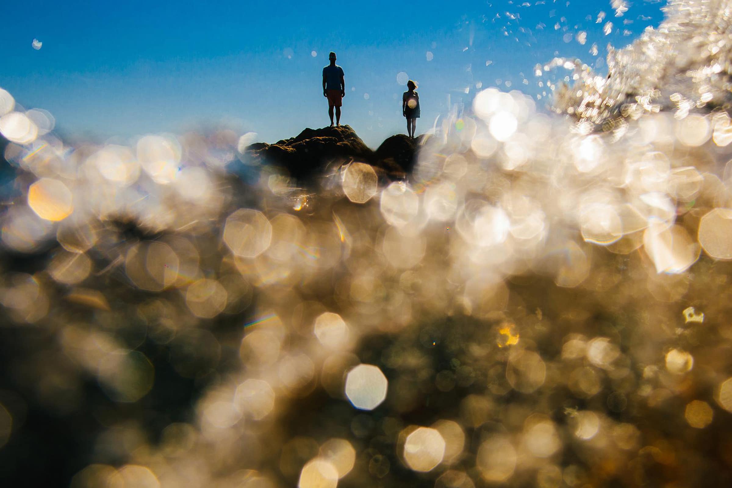 a couple stood on rocks in italy