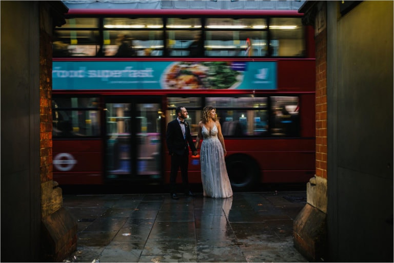 a bride and groom on the streets of london at their london wedding