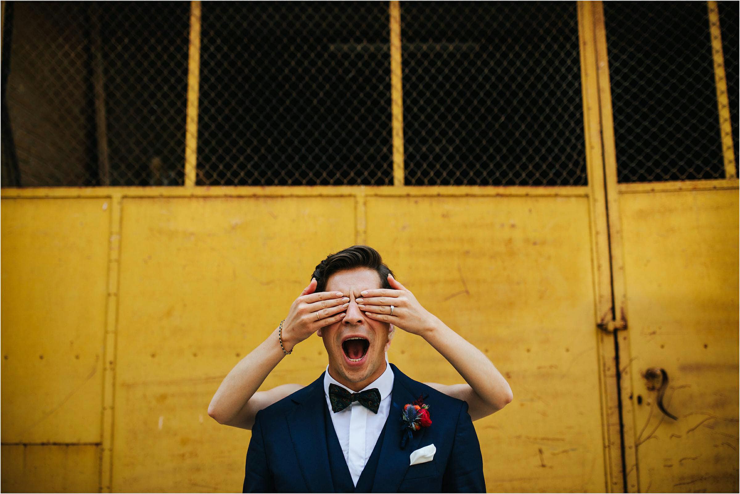 a bride hides her grooms eyes on a destination wedding