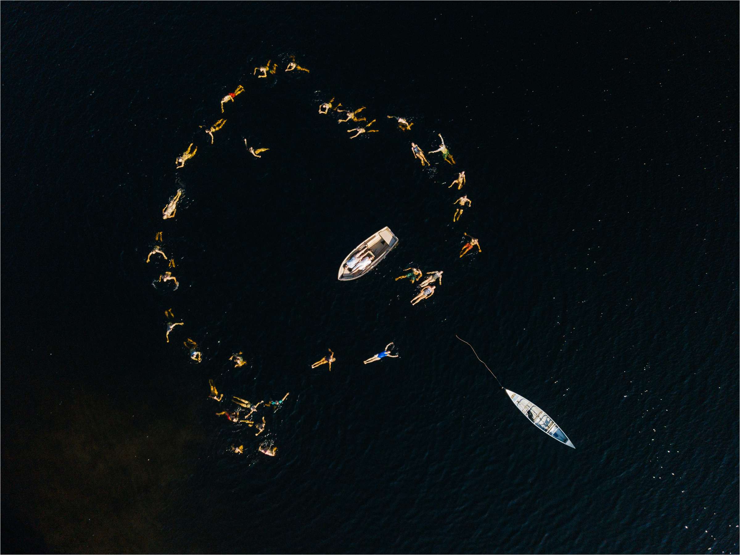 an award winning drone photograph of people in a lake