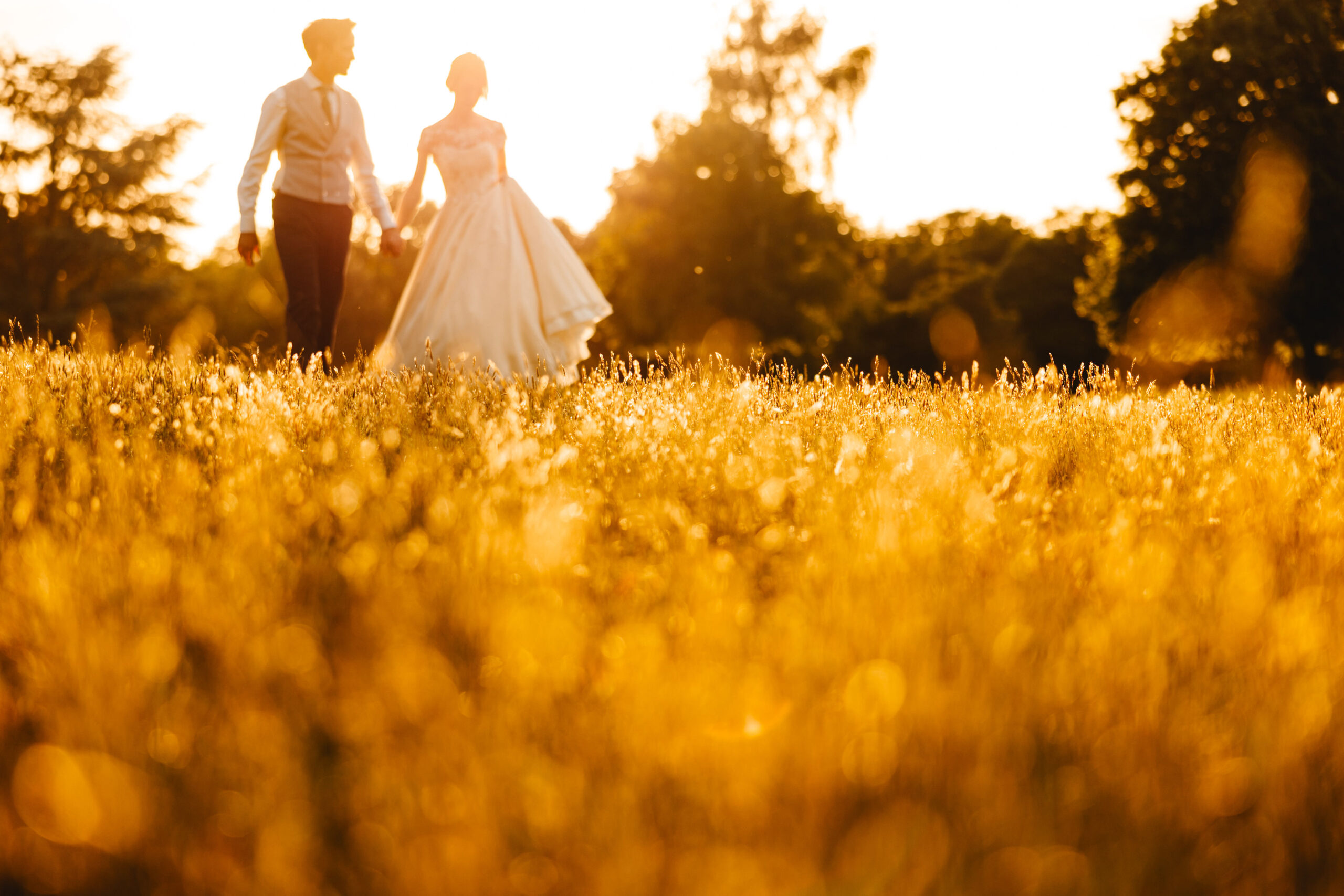 a couple walking through a field in France